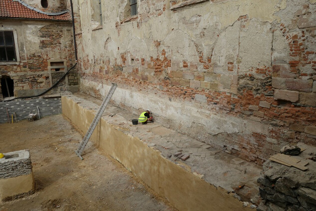 Výškový rozdíl mezi barokní podlahou (s archeoložkou) a podlahou humna v 19. st. (vlevo dole).